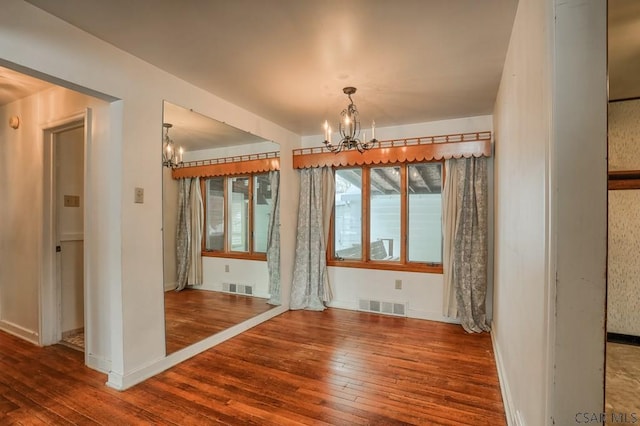 interior space featuring hardwood / wood-style flooring and a chandelier