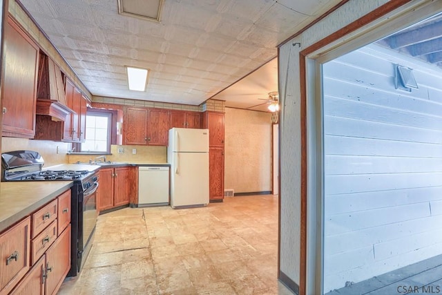 kitchen featuring ceiling fan, white appliances, and sink