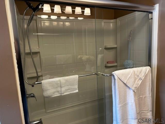 bathroom with a shower with door