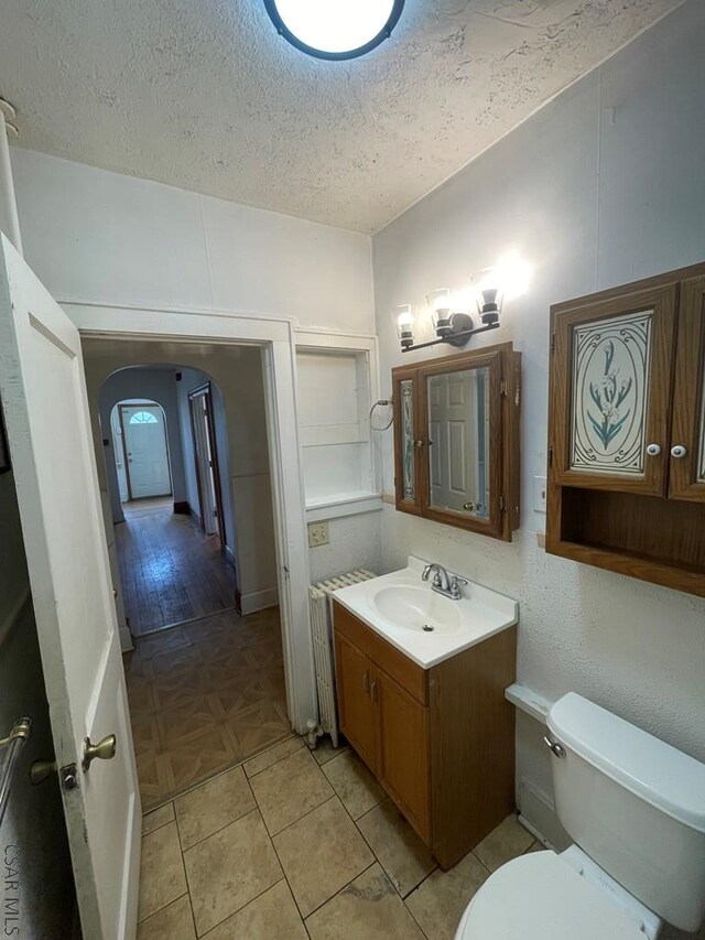 161 Stone St, Johnstown, PA 15906 - half bathroom featuring vanity, a textured ceiling, and toilet