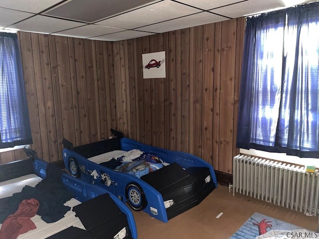 161 Stone St, Johnstown, PA 15906 - bedroom with radiator heating unit, wood walls, and a paneled ceiling