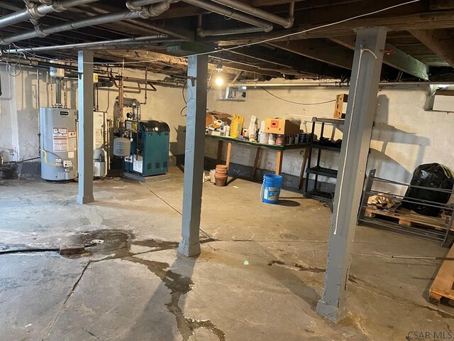 161 Stone St, Johnstown, PA 15906 - unfinished below grade area with water heater, a heating unit, and a workshop area