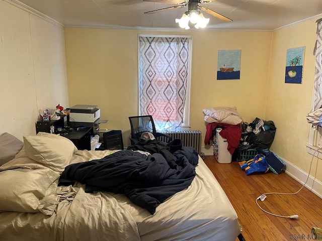 161 Stone St, Johnstown, PA 15906 - bedroom with ornamental molding, radiator, hardwood / wood-style flooring, a ceiling fan, and baseboards