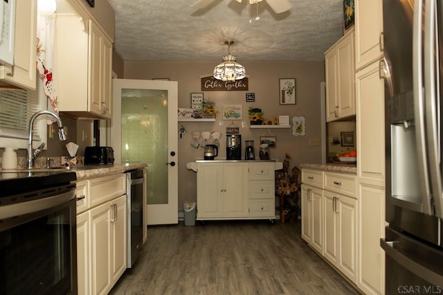 kitchen featuring dark hardwood / wood-style floors, hanging light fixtures, ceiling fan, stainless steel refrigerator with ice dispenser, and a textured ceiling