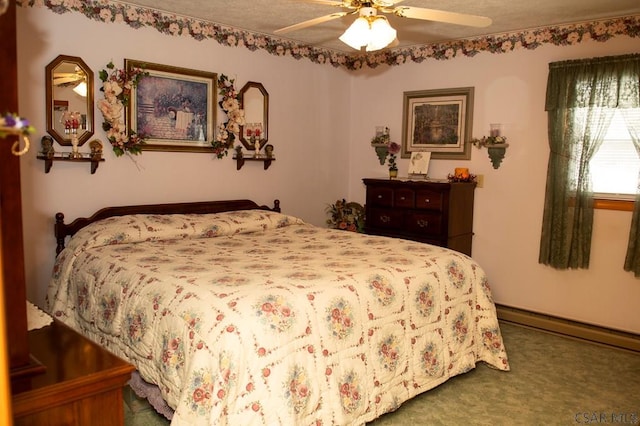 carpeted bedroom featuring ceiling fan and a baseboard heating unit