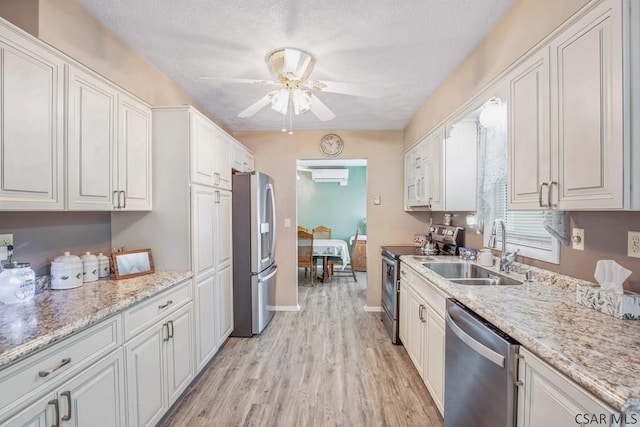 3313 Berlin Plank Rd, Berlin, PA 15530 - kitchen with a ceiling fan, a sink, stainless steel appliances, light wood-style flooring, and white cabinetry
