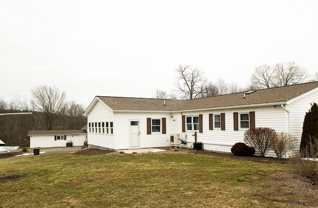 rear view of house with a lawn