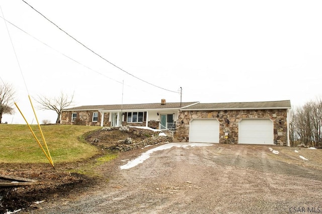 ranch-style house with a garage and a front yard