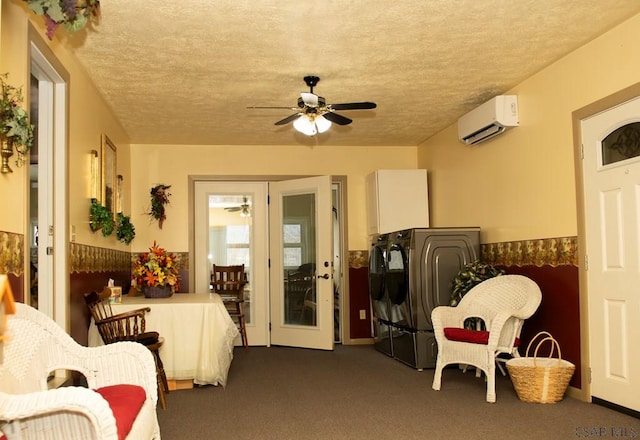 sunroom with ceiling fan, washer and clothes dryer, and a wall unit AC