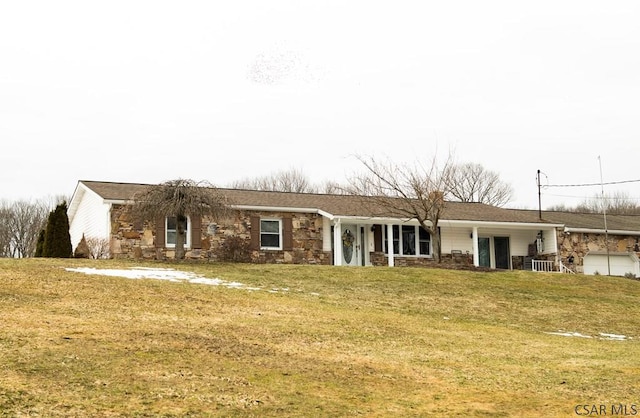 single story home featuring a garage and a front lawn