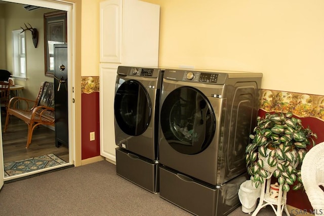 laundry room with cabinets, carpet flooring, and washing machine and clothes dryer