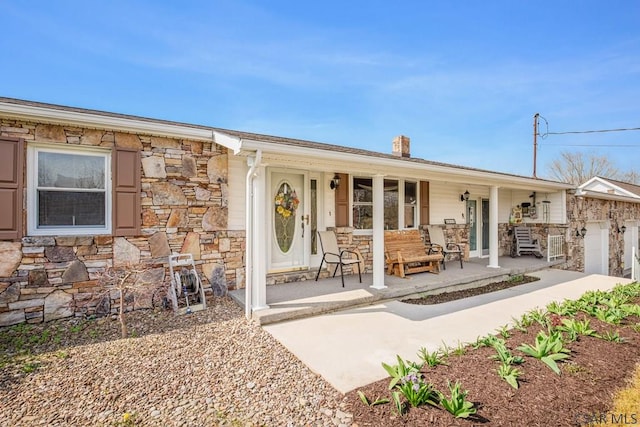 3313 Berlin Plank Rd, Berlin, PA 15530 - view of front facade with stone siding, a chimney, and covered porch