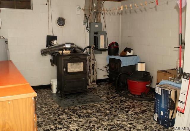 basement featuring electric panel and a wood stove