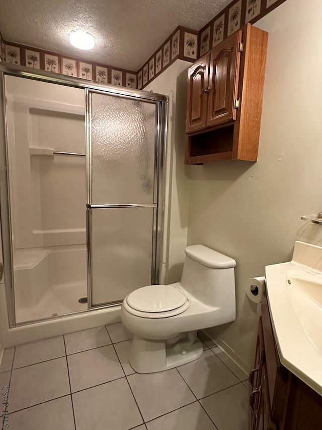 bathroom with vanity, tile patterned floors, a textured ceiling, and a shower with shower door