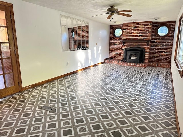 unfurnished living room with ceiling fan