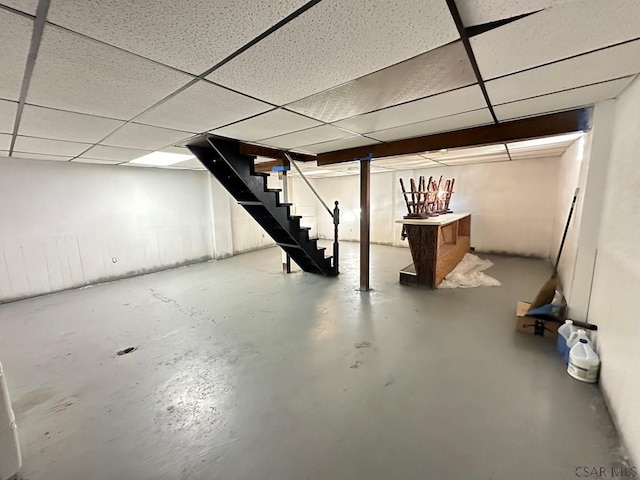 basement with a paneled ceiling