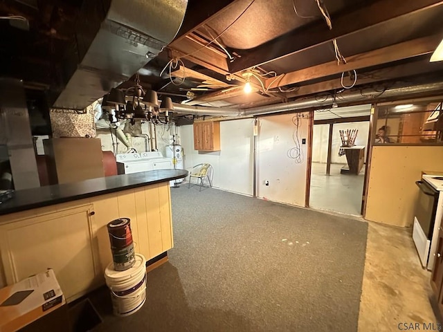 basement with electric water heater and independent washer and dryer