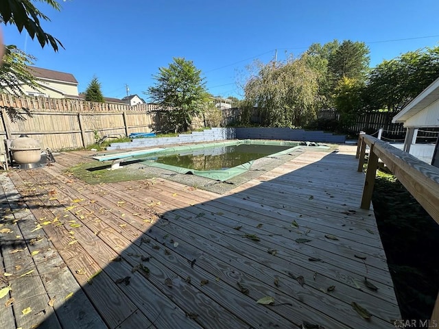 wooden deck with a covered pool