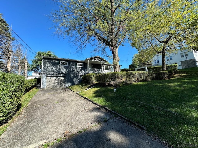 view of front of house with a garage and a front yard