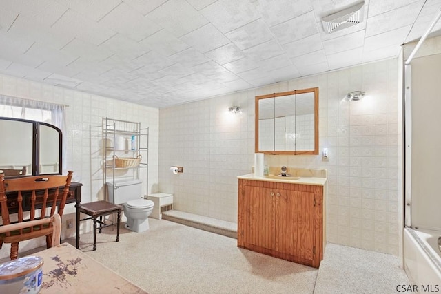 full bathroom featuring shower / bath combination with glass door, vanity, and toilet