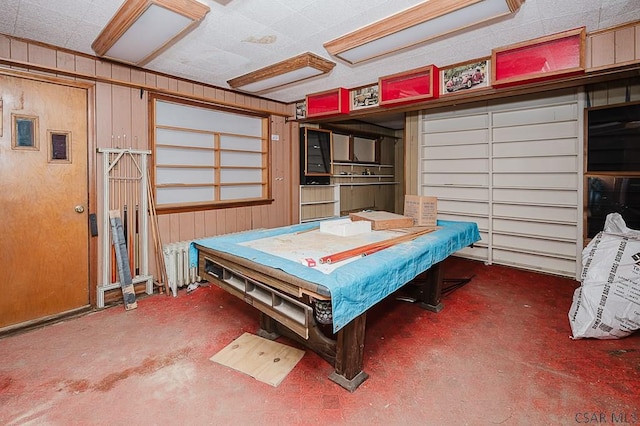 bedroom featuring wooden walls