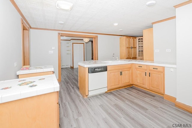 kitchen with tile countertops, light wood-style flooring, white dishwasher, light brown cabinetry, and a sink