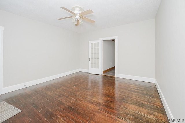 empty room featuring wood-type flooring, baseboards, and a ceiling fan