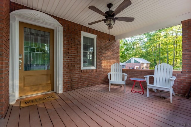 wooden deck featuring ceiling fan