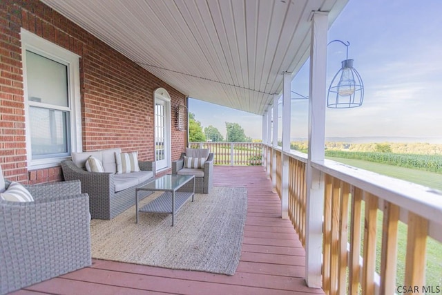 wooden terrace featuring outdoor lounge area