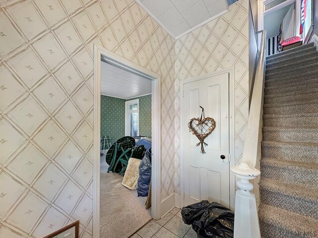 521 N Julian St, Ebensburg, PA 15931 - foyer featuring stairway, light carpet, wallpapered walls, and light tile patterned flooring