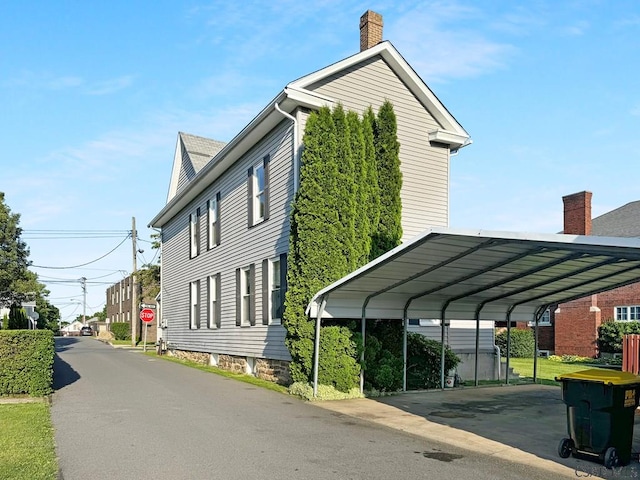 521 N Julian St, Ebensburg, PA 15931 - view of home's exterior featuring a carport and a chimney