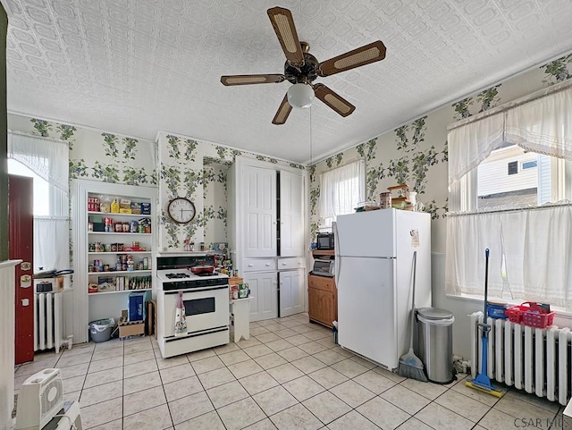 521 N Julian St, Ebensburg, PA 15931 - kitchen featuring white appliances, radiator, a ceiling fan, plenty of natural light, and an ornate ceiling