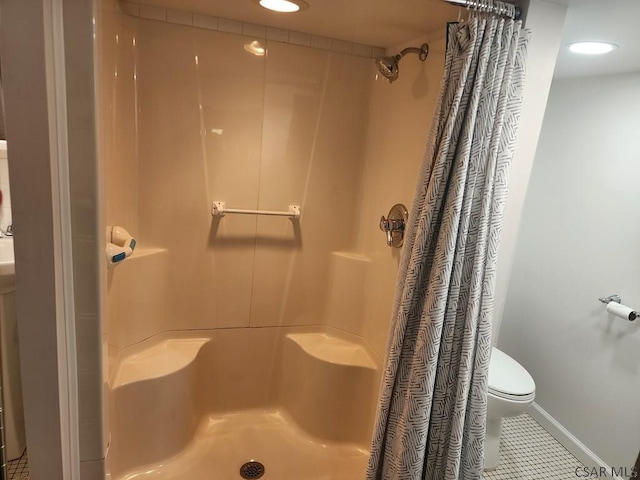 bathroom featuring a shower with curtain, toilet, and tile patterned flooring