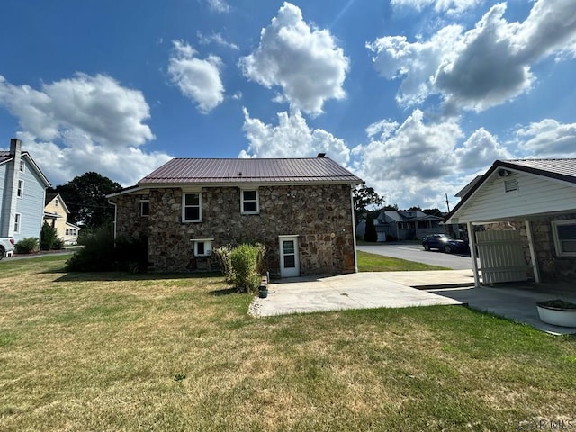 rear view of property featuring a patio and a yard