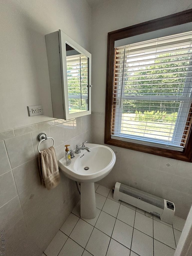 bathroom featuring a baseboard radiator, tile patterned flooring, and tile walls