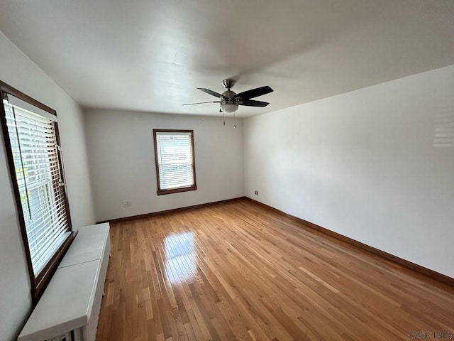 unfurnished room featuring ceiling fan and light wood-type flooring