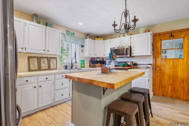 408 Byers Rd, Somerset, PA 15501 - kitchen with white cabinetry, a sink, butcher block countertops, and appliances with stainless steel finishes