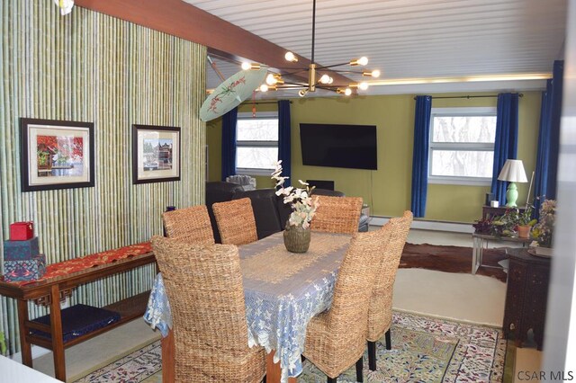 dining area featuring a healthy amount of sunlight, beamed ceiling, and a chandelier