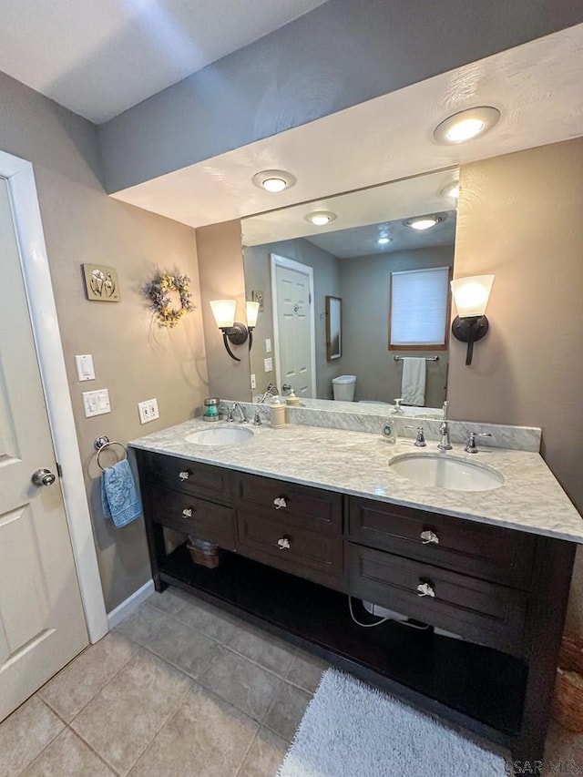 bathroom featuring tile patterned floors, vanity, and toilet