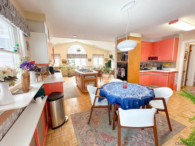 dining area featuring lofted ceiling and light parquet floors