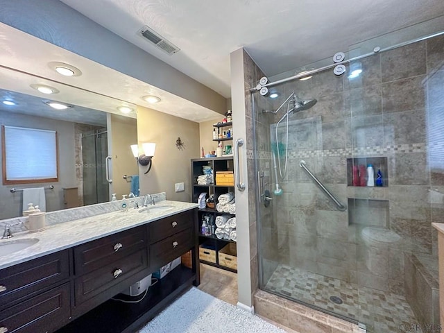 bathroom featuring vanity and a shower with shower door