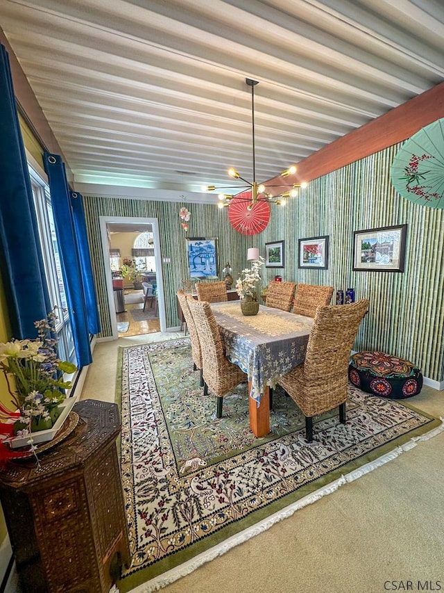 carpeted dining space with a chandelier