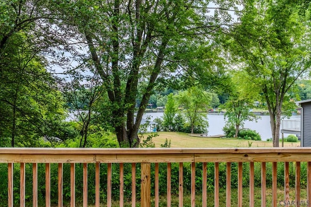 wooden terrace with a lawn and a water view