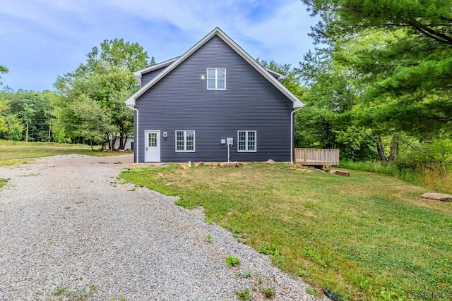 view of side of property with a lawn