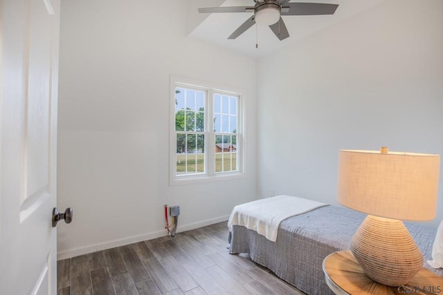 bedroom with ceiling fan and dark hardwood / wood-style flooring