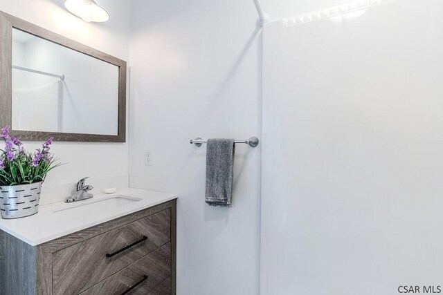 bathroom with vanity and walk in shower