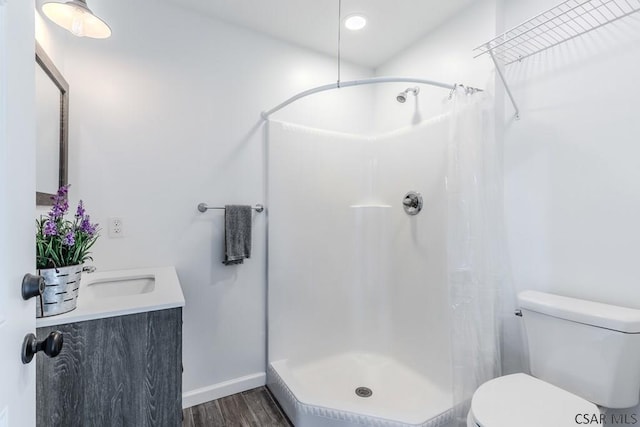 bathroom featuring vanity, wood-type flooring, toilet, and a shower with shower curtain