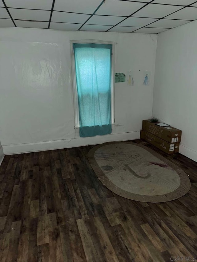 unfurnished room featuring a drop ceiling and wood finished floors