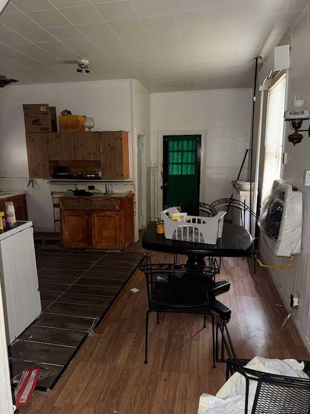 dining space with dark wood finished floors and washer / dryer