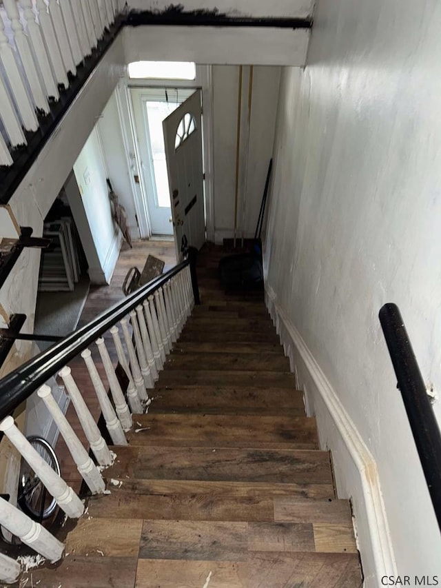 staircase with wood finished floors